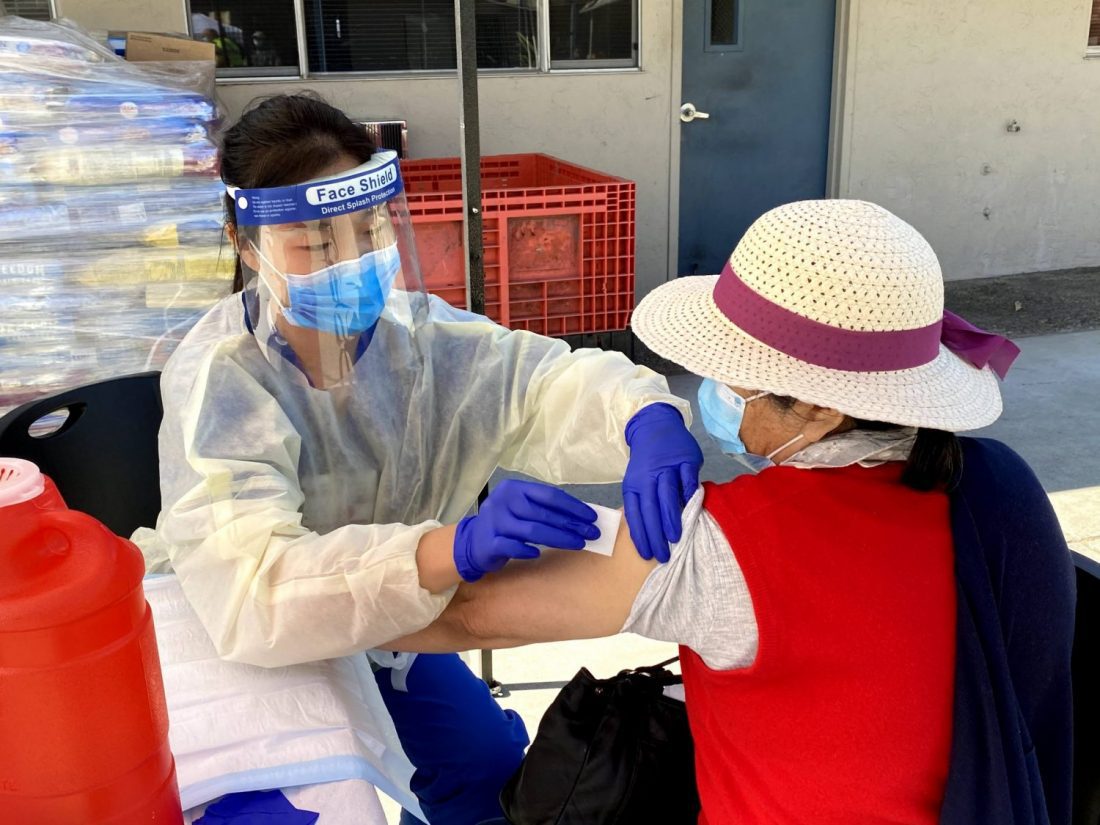 Senior being prepared for flu shot