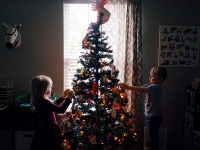 Children decorating christmas tree