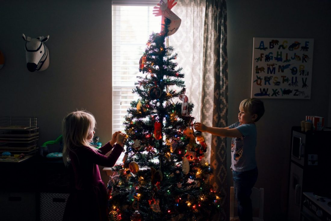 Children decorating christmas tree