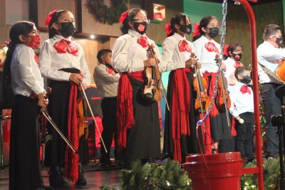 Children in a mariachi program perform at a Christmas event.