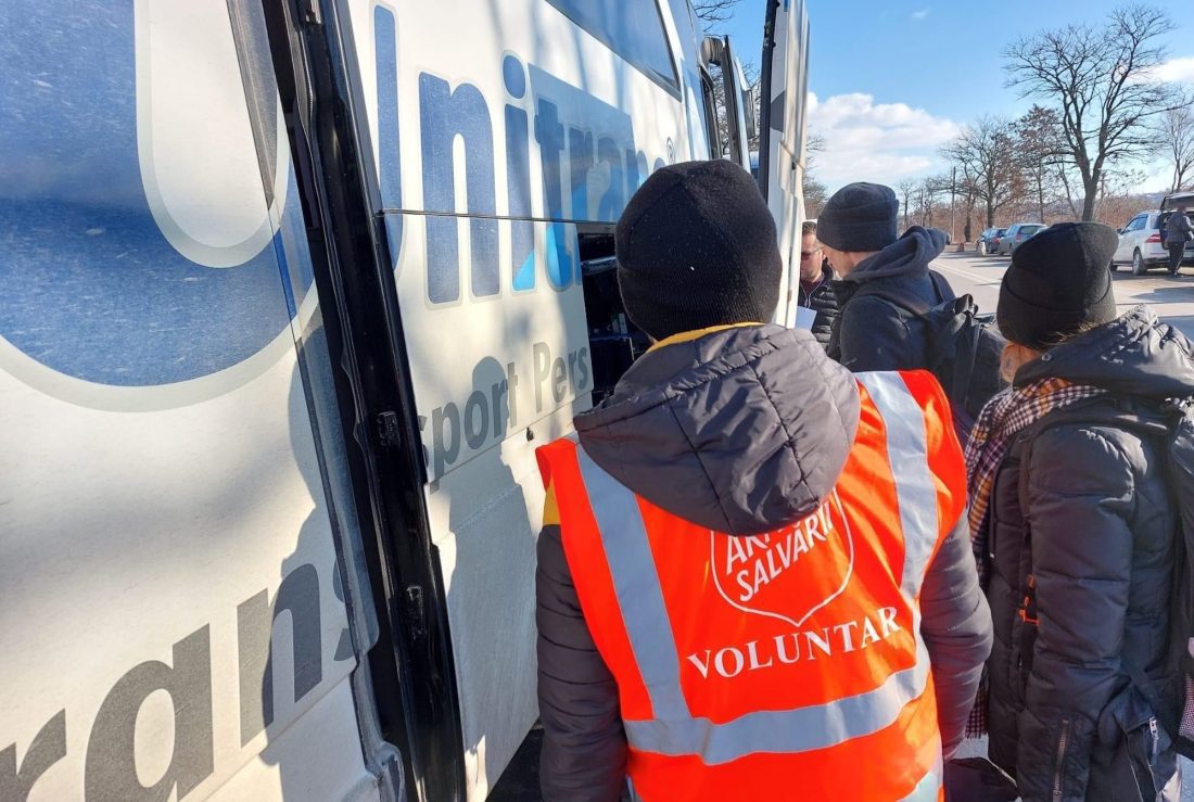 volunteers help unload a supply van in ukraine