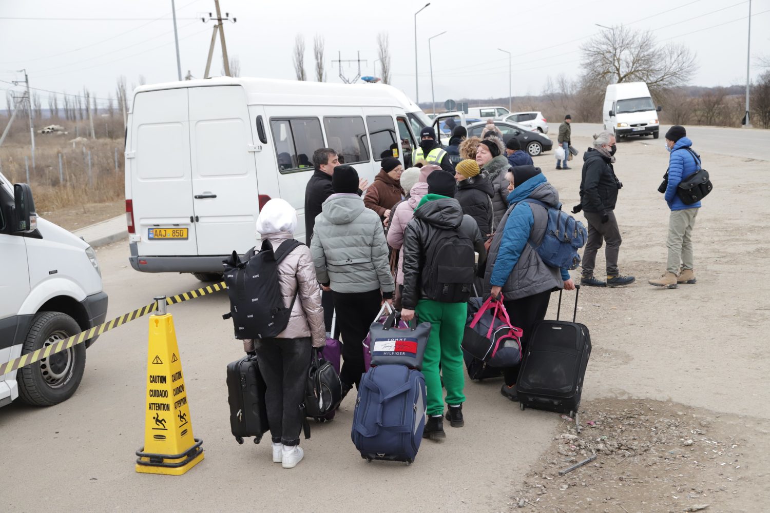 Ukrainian refugees board vans with their luggage 