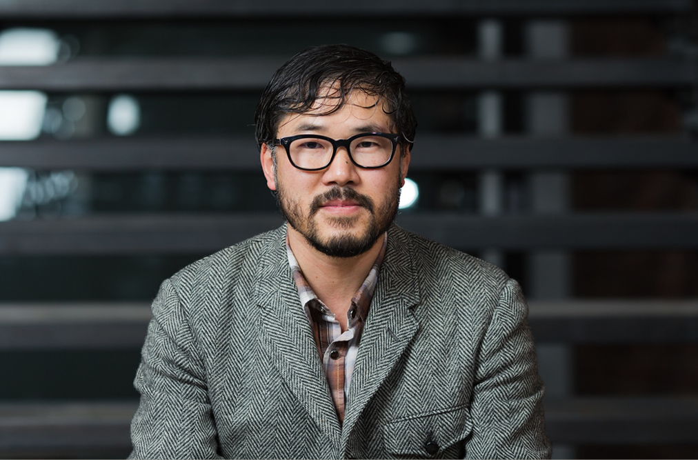 man with glasses and gray jacket