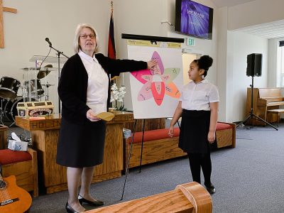 female salvation army officer teaches bible study