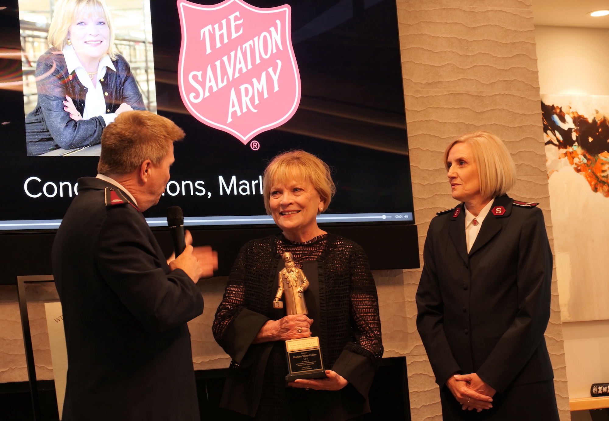 woman receives an award on stage