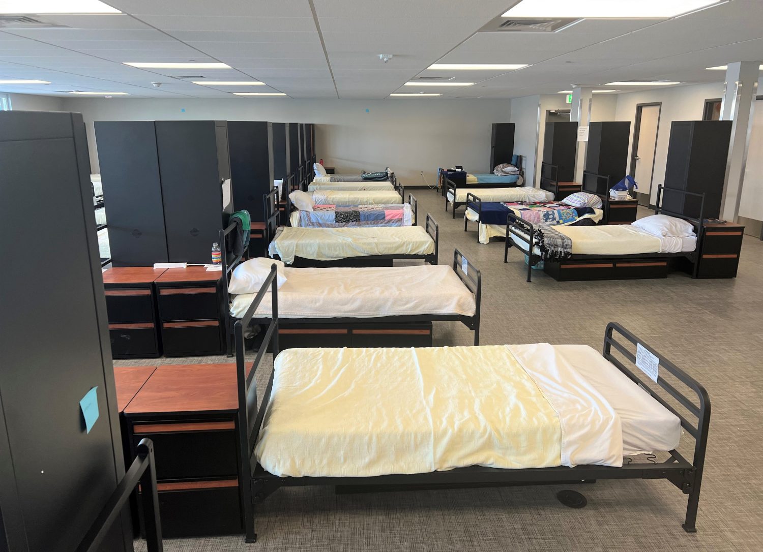 large room in homeless shelter with multiple beds