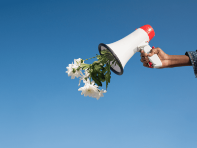 person holding a megaphone with flowers coming out of it