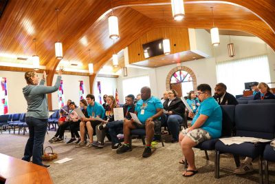 Delegates at Salvation Army Adaptive Retreat practice songs in chapel.